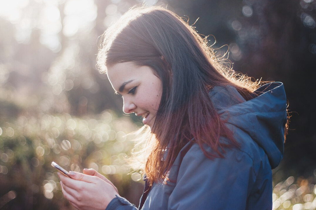 teenager scrolling phone