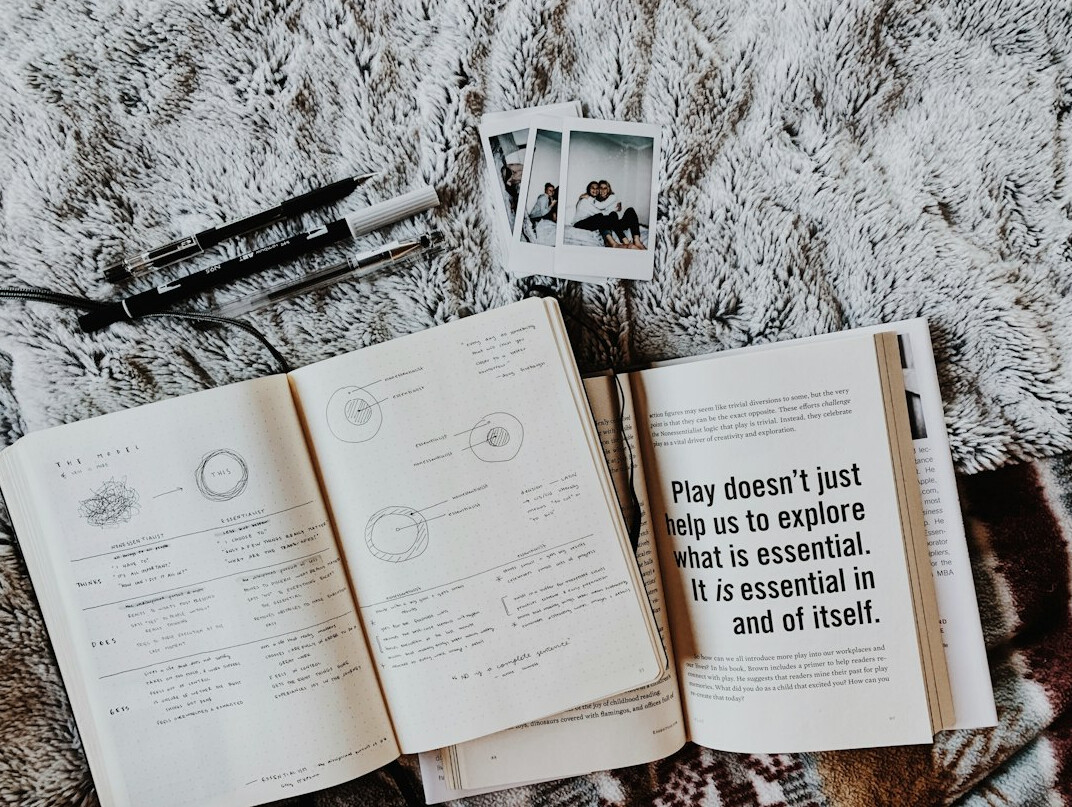 Open notebook with handwritten notes and a pen
