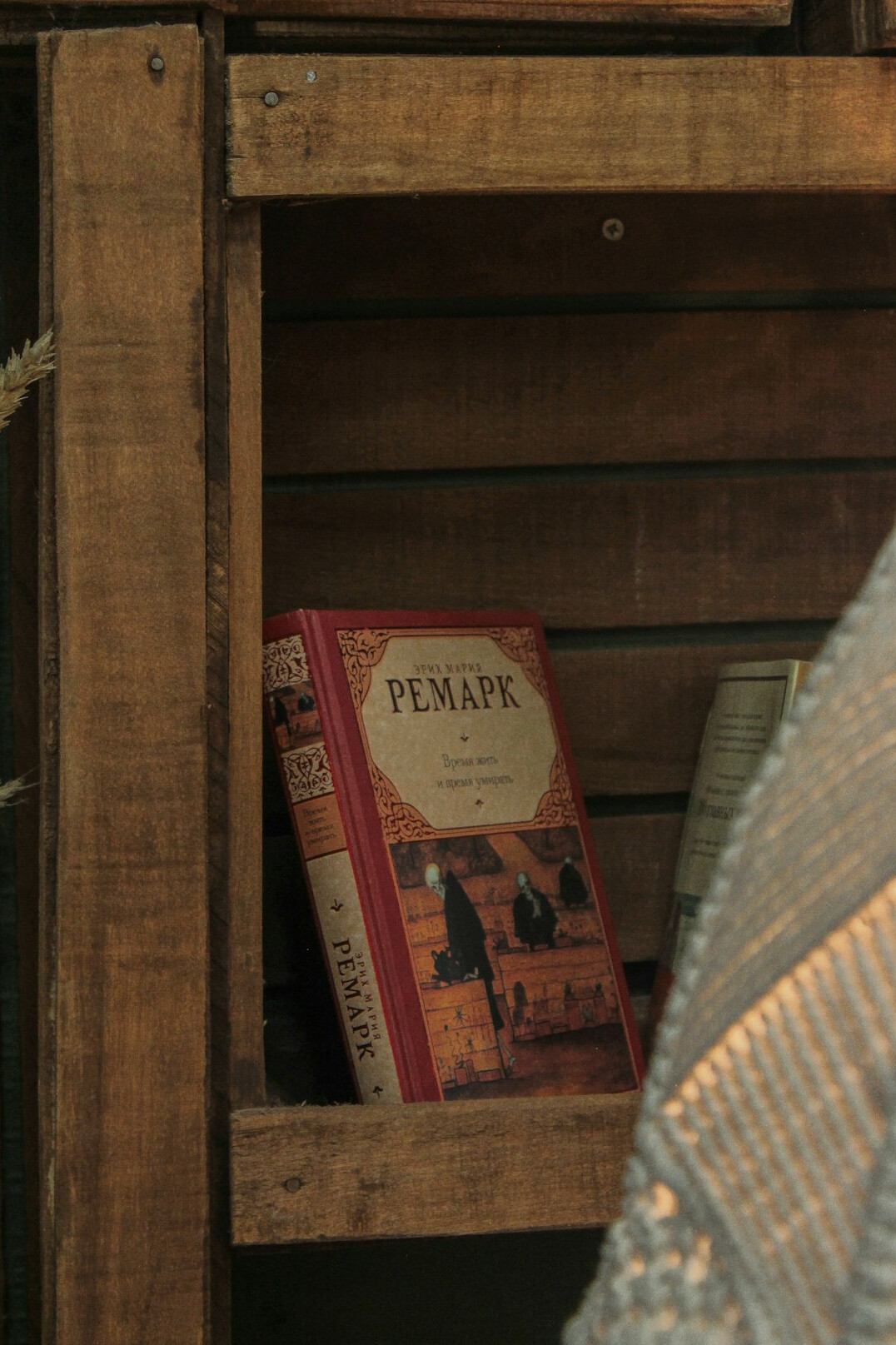 Neatly stacked old books on a wooden shelf